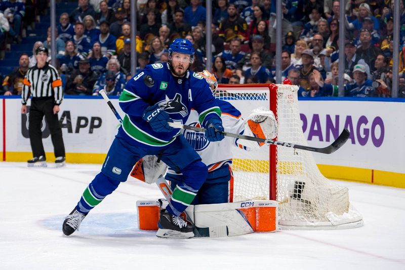 May 20, 2024; Vancouver, British Columbia, CAN; Vancouver Canucks forward J.T. Miller (9) watches the flying puck in front of Edmonton Oilers goalie Stuart Skinner (74) during the first period in game seven of the second round of the 2024 Stanley Cup Playoffs at Rogers Arena. Mandatory Credit: Bob Frid-USA TODAY Sports