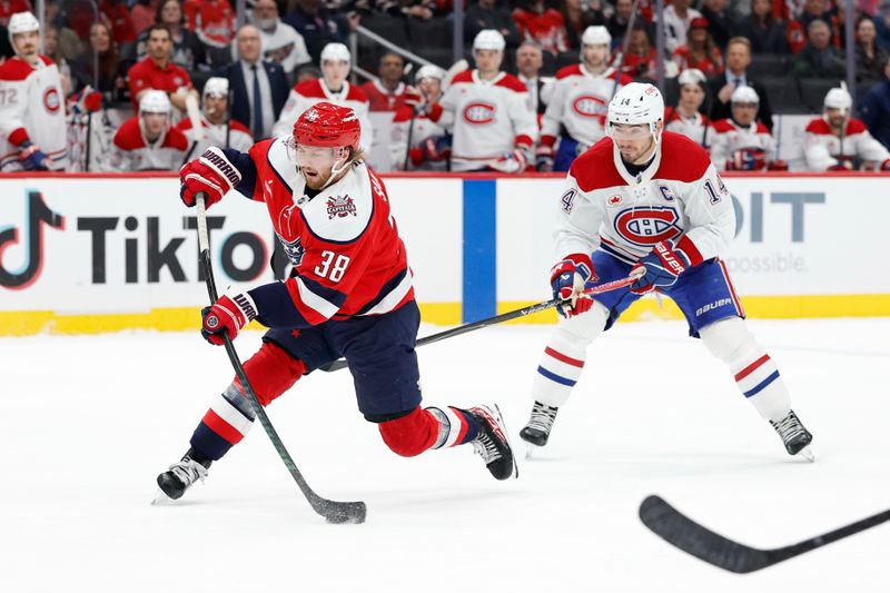 Jan 13, 2026; Washington, District of Columbia, USA; Washington Capitals defenseman Rasmus Sandin (38) shoots the puck as Montréal Canadiens center Nick Suzuki (14) chases during the third period at Capital One Arena. Mandatory Credit: Geoff Burke-Imagn Images