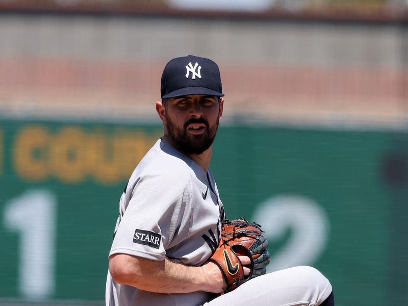 May 10, 2025; West Sacramento, California, USA; New York Yankees starting pitcher Carlos Rodon (55) winds up for a pitch against the Athletics during the first inning at Sutter Health Park. Mandatory Credit: Dennis Lee-Imagn Images