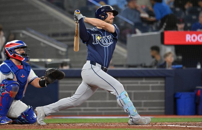 May 14, 2025; Toronto, Ontario, CAN;  Tampa Bay Rays second baseman Brandon Lowe (8) hits a double against the Toronto Blue Jays in the third inning at Rogers Centre. Mandatory Credit: Dan Hamilton-Imagn Images