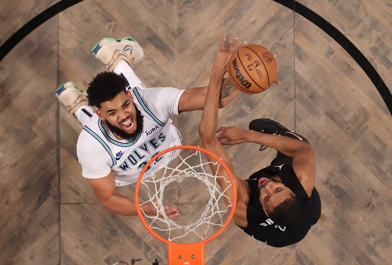 NEW YORK, NEW YORK - JANUARY 25:  Karl-Anthony Towns #32 of the Minnesota Timberwolves shoots against Mikal Bridges #1 of the Brooklyn Nets  during their game at Barclays Center on January 25, 2024 in New York City.  User expressly acknowledges and agrees that, by downloading and or using this photograph, User is consenting to the terms and conditions of the Getty Images License Agreement.  (Photo by Al Bello/Getty Images)