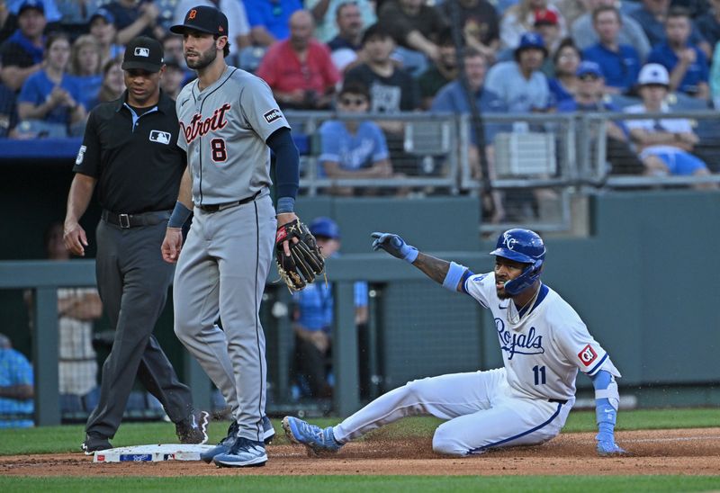 May 21, 2024; Kansas City, Missouri, USA;  Kansas City Royals third baseman Maikel Garcia (11) slides into third base an RBI triple in the third inning against Detroit Tigers third baseman Matt Vierling (8) at Kauffman Stadium. Mandatory Credit: Peter Aiken-USA TODAY Sports