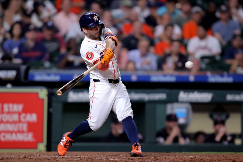 Apr 30, 2024; Houston, Texas, USA; Houston Astros second baseman Jose Altuve (27) hits a single against the Cleveland Guardians during the eighth inning at Minute Maid Park. Mandatory Credit: Erik Williams-USA TODAY Sports