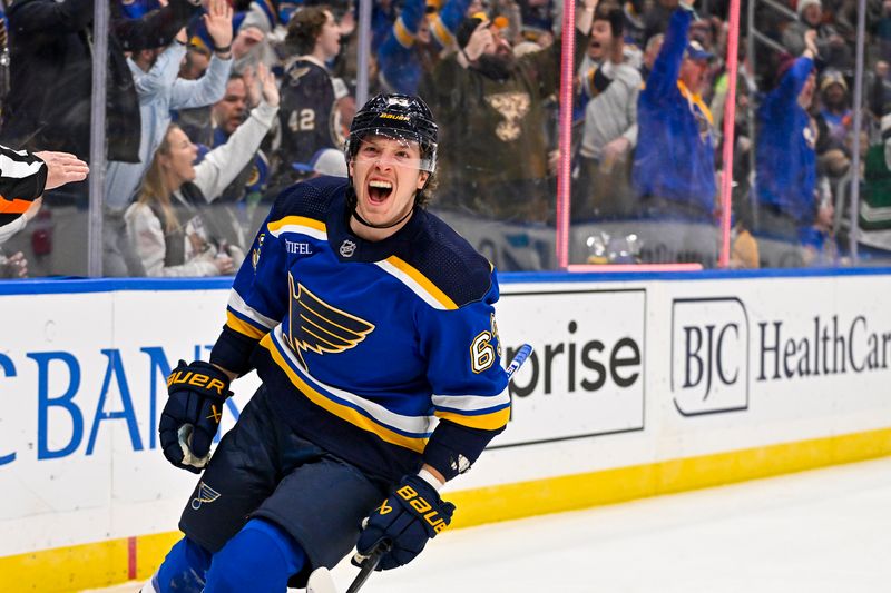 Nov 3, 2023; St. Louis, Missouri, USA;  St. Louis Blues left wing Jake Neighbours (63) reacts after scoring against the New Jersey Devils during the second period at Enterprise Center. Mandatory Credit: Jeff Curry-USA TODAY Sports