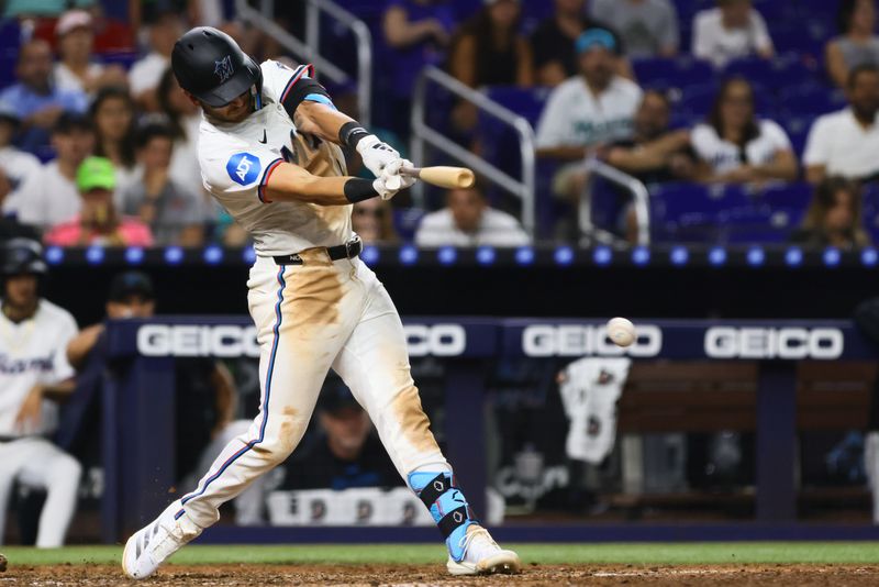 Aug 19, 2024; Miami, Florida, USA; Miami Marlins left fielder Kyle Stowers (28) hits an RBI single against the Arizona Diamondbacks during the sixth inning at loanDepot Park. Mandatory Credit: Sam Navarro-USA TODAY Sports