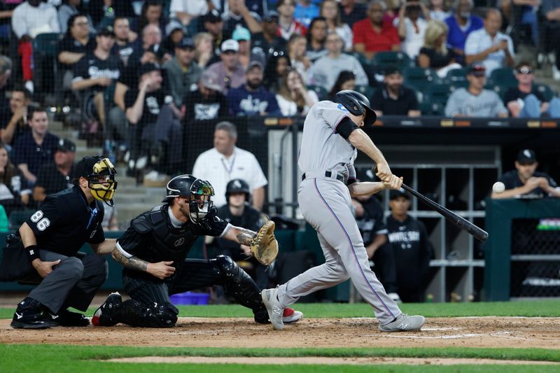 Jun 9, 2023; Chicago, Illinois, USA; Miami Marlins shortstop Joey Wendle (18) hits a solo home run against the Chicago White Sox during the fifth inning at Guaranteed Rate Field. Mandatory Credit: Kamil Krzaczynski-USA TODAY Sports