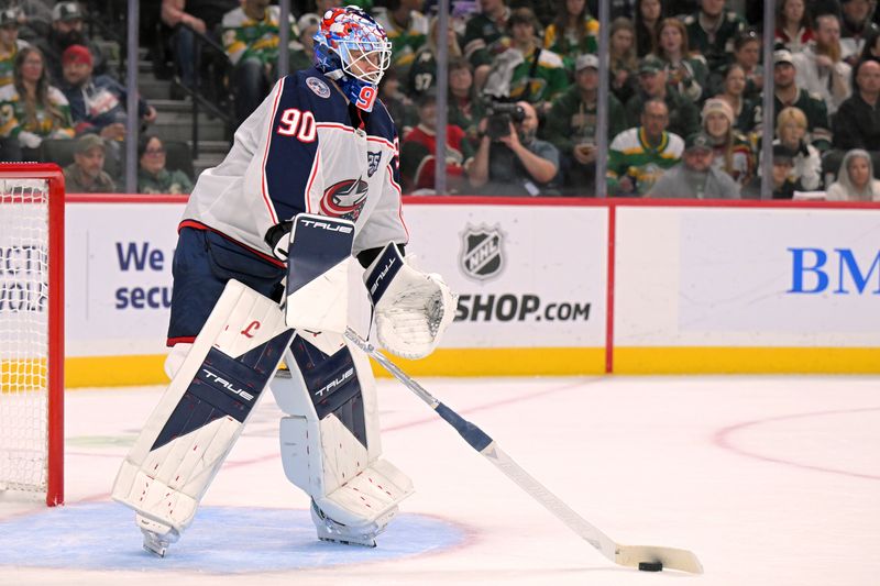 Oct 11, 2025; Saint Paul, Minnesota, USA;  Columbus Blue Jackets goalie Elvis Merzlikins (90) controls the puck against the Minnesota Wild during the second period at Grand Casino Arena. Mandatory Credit: Nick Wosika-Imagn Images