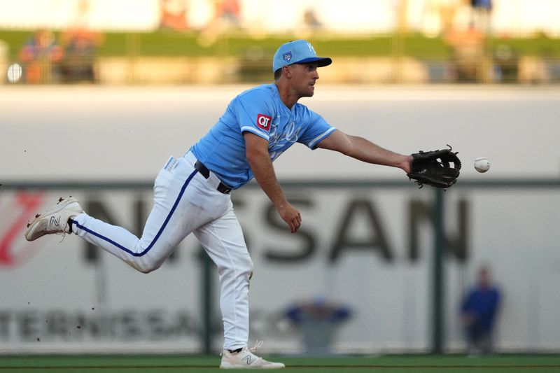 Mar 5, 2024; Surprise, Arizona, USA; Kansas City Royals second baseman Adam Frazier (26) flips the ball to first against the Chicago Cubs during the first inning at Surprise Stadium. Mandatory Credit: Joe Camporeale-USA TODAY Sports