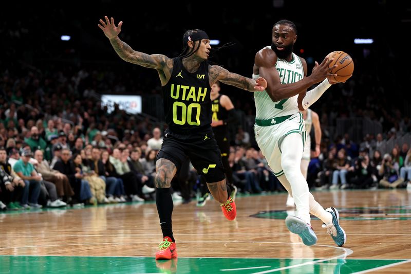 BOSTON, MASSACHUSETTS - JANUARY 05: Jaylen Brown #7 of the Boston Celtics drives to the basket against Jordan Clarkson #00 of the Utah Jazz during the first quarter at TD Garden on January 05, 2024 in Boston, Massachusetts. NOTE TO USER: User expressly acknowledges and agrees that, by downloading and or using this photograph, user is consenting to the terms and conditions of the Getty Images License Agreement.  (Photo by Maddie Meyer/Getty Images)