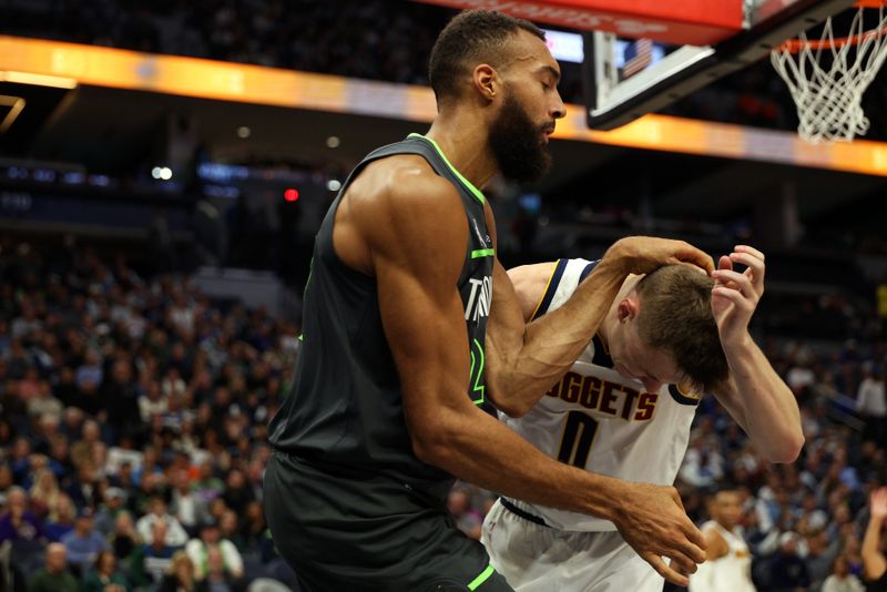 MINNEAPOLIS, MINNESOTA - NOVEMBER 01: Rudy Gobert #27 of the Minnesota Timberwolves and Christian Braun #0 of the Denver Nuggets get into a scrum in the fourth quarter. Gobert and Braun received technical fouls at Target Center on November 01, 2024 in Minneapolis, Minnesota. The Timberwolves defeated the Nuggets 119-116. NOTE TO USER: User expressly acknowledges and agrees that, by downloading and or using this photograph, User is consenting to the terms and conditions of the Getty Images License Agreement. (Photo by David Berding/Getty Images)