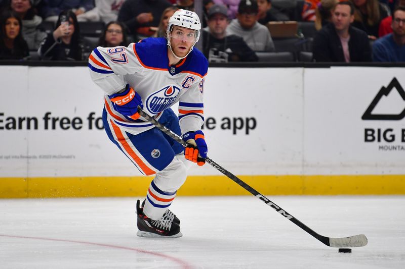 Dec 30, 2023; Los Angeles, California, USA; Edmonton Oilers center Connor McDavid (97) controls the puck against the Los Angeles Kings during the third period at Crypto.com Arena. Mandatory Credit: Gary A. Vasquez-USA TODAY Sports