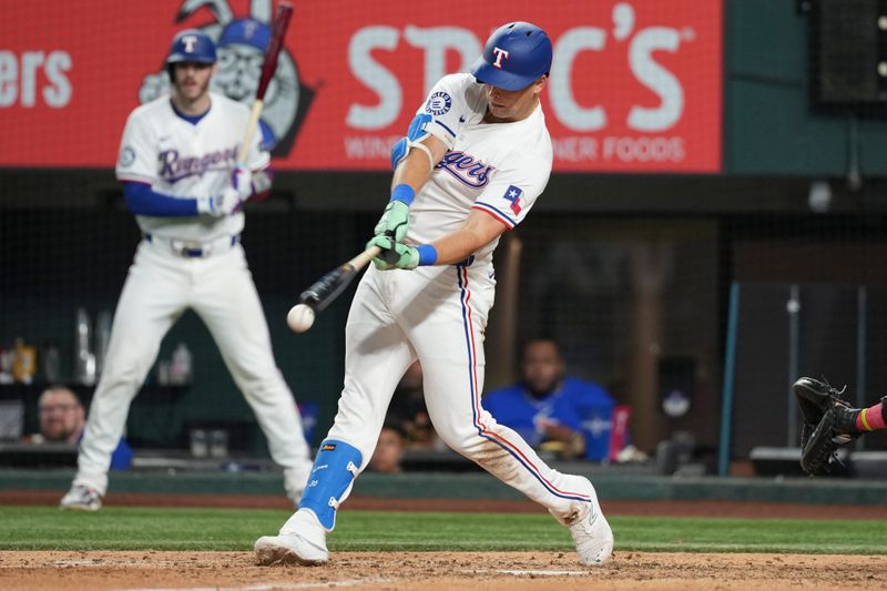 Sep 7, 2024; Arlington, Texas, USA; Texas Rangers first baseman Nathaniel Lowe (30) singles against the Los Angeles Angels during the eighth inning at Globe Life Field. Mandatory Credit: Jim Cowsert-Imagn Images