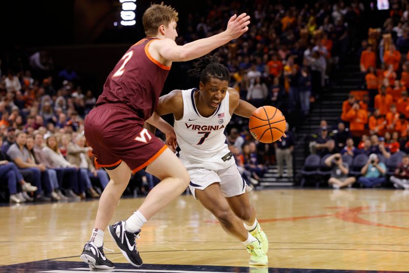 Feb 1, 2025; Charlottesville, Virginia, USA; Virginia Cavaliers guard Dai Dai Ames (7) controls the ball as Virginia Tech Hokies guard Jaden Schutt (2) defends during the second half at John Paul Jones Arena. Mandatory Credit: Amber Searls-Imagn Images