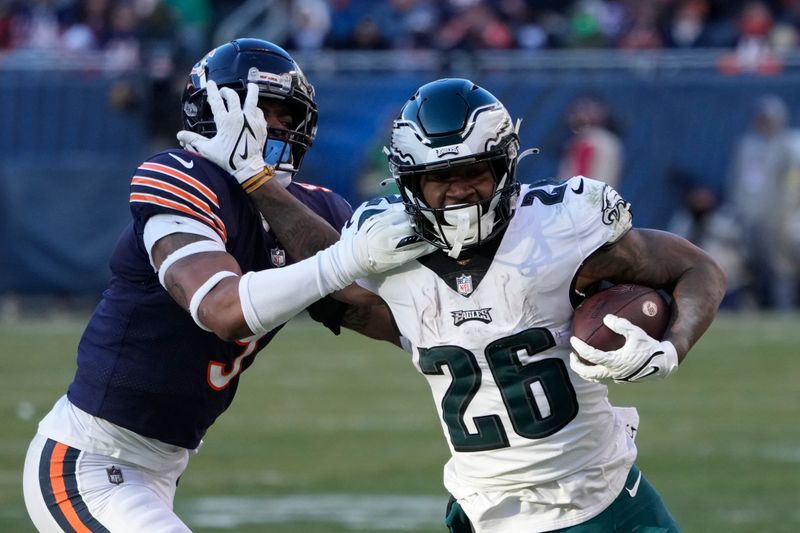 Philadelphia Eagles' Miles Sanders, right, tries to get free of Chicago Bears' Jaquan Brisker during the second half of an NFL football game, Sunday, Dec. 18, 2022, in Chicago. (AP Photo/Charles Rex Arbogast)