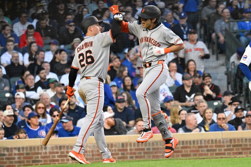 May 6, 2025; Chicago, Illinois, USA;  San Francisco Giants outfielder Jung Hoo Lee (51) high fives  third baseman Matt Chapman (26)  after hitting a two run home run against the Chicago Cubs during the third inning at Wrigley Field. Mandatory Credit: Matt Marton-Imagn Images