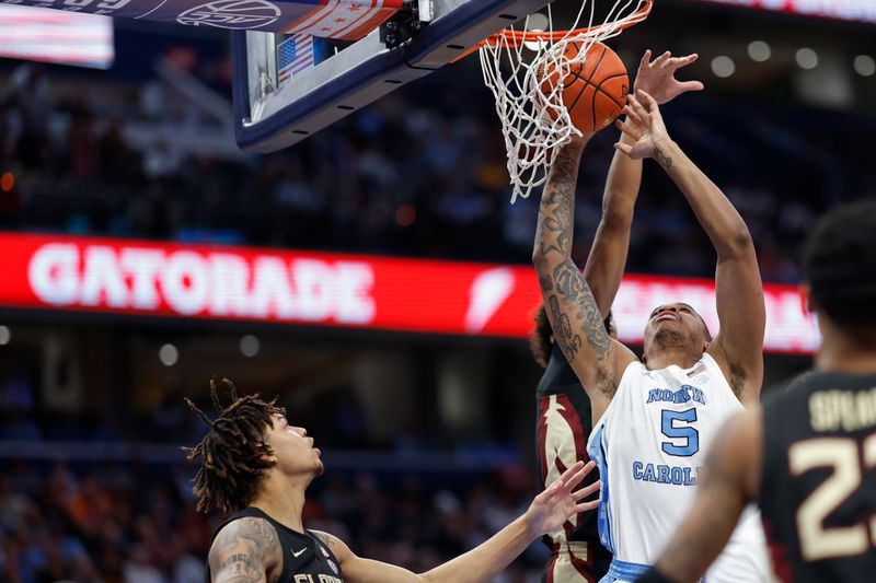 Mar 14, 2024; Washington, D.C., USA; North Carolina forward Armando Bacot (5) shoots the ball as Florida State forward Baba Miller (11) defends in the second half at Capital One Arena. Mandatory Credit: Geoff Burke-USA TODAY Sports