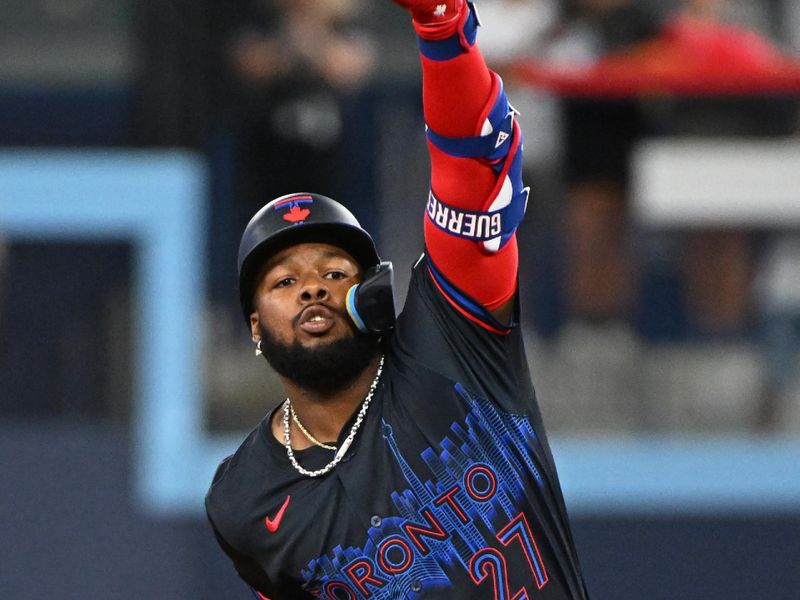 Aug 8, 2024; Toronto, Ontario, CAN; Toronto Blue Jays first base Vladimir Guerrero Jr. (27) celebrates a RBI double in the fist inning against the Baltimore Orioles at Rogers Centre. Mandatory Credit: Gerry Angus-USA TODAY Sports