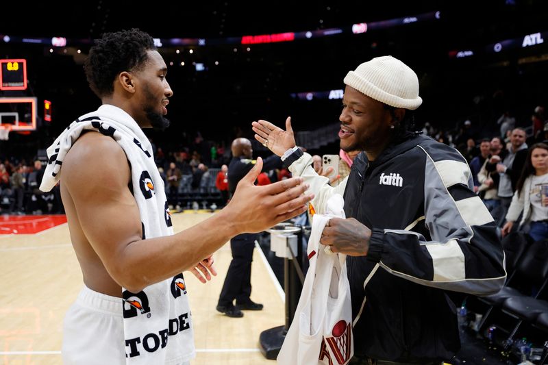 ATLANTA, GEORGIA - JANUARY 20: Donovan Mitchell #45 of the Cleveland Cavaliers greets D.C. Young Fly after the game against the Atlanta Hawks at State Farm Arena on January 20, 2024 in Atlanta, Georgia. NOTE TO USER: User expressly acknowledges and agrees that, by downloading and or using this photograph, User is consenting to the terms and conditions of the Getty Images License Agreement. (Photo by Alex Slitz/Getty Images)