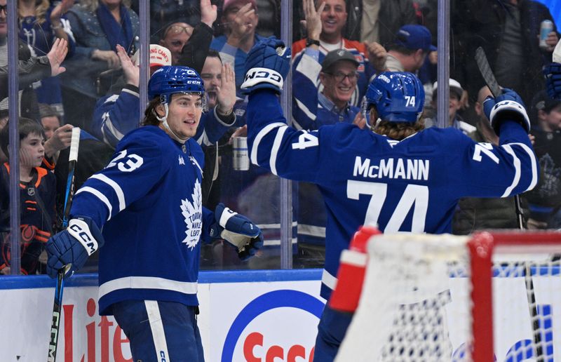 Nov 16, 2024; Toronto, Ontario, CAN;  Toronto Maple Leafs forward Matthew Knies (23) celebrates with forward Bobby McMann (74) after scoring against the Edmonton Oilers in the third period at Scotiabank Arena. Mandatory Credit: Dan Hamilton-Imagn Images