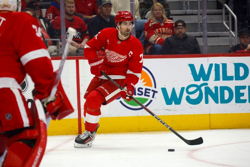 Nov 2, 2024; Detroit, Michigan, USA; Detroit Red Wings center Dylan Larkin (71) handles the puck during the first period of the game against the Buffalo Sabres at Little Caesars Arena. Mandatory Credit: Brian Bradshaw Sevald-Imagn Images