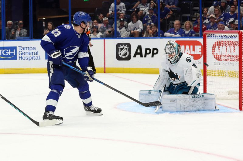 wOct 26, 2023; Tampa, Florida, USA; Tampa Bay Lightning center Michael Eyssimont (23) shoots as San Jose Sharks goaltender Kaapo Kahkonen (36) makes a save during the third period at Amalie Arena. Mandatory Credit: Kim Klement Neitzel-USA TODAY Sports