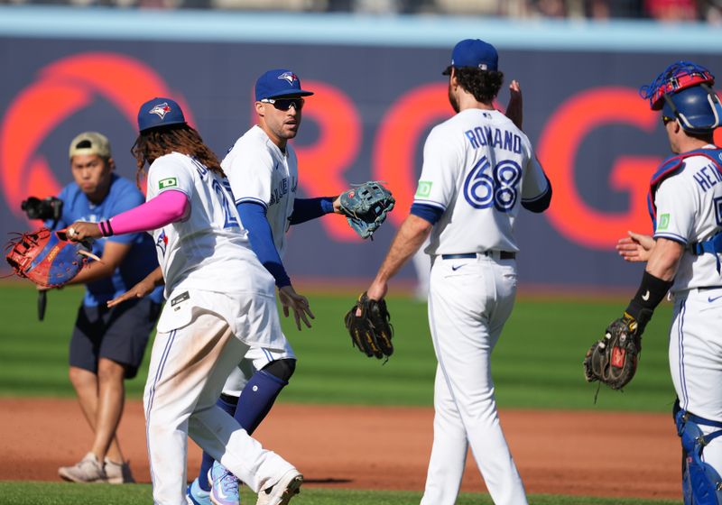 Sep 10, 2023; Toronto, Ontario, CAN; Toronto Blue Jays first baseman Vladimir Guerrero Jr. (27) and right fielder George Springer (4) celebrate the win against the Kansas City Royals at the end of the ninth inning at Rogers Centre. Mandatory Credit: Nick Turchiaro-USA TODAY Sports