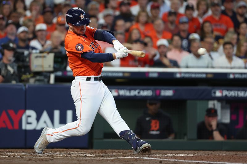 Oct 2, 2024; Houston, Texas, USA; Houston Astros third base Alex Bregman (2) hits a single against the Detroit Tigers during the second inning of game two of the Wildcard round for the 2024 MLB Playoffs at Minute Maid Park. Mandatory Credit: Thomas Shea-Imagn Images