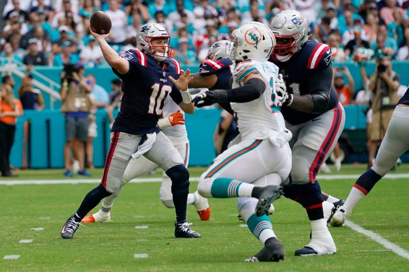 New England Patriots quarterback Mac Jones (10) passes the football during the second half of an NFL football game against the Miami Dolphins, Sunday, Oct. 29, 2023, in Miami Gardens, Fla. (AP Photo/Lynne Sladky)