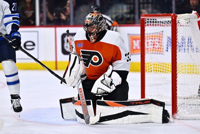 Feb 8, 2024; Philadelphia, Pennsylvania, USA; Philadelphia Flyers goalie Samuel Ersson (33) makes a save against the Winnipeg Jets in the second period at Wells Fargo Center. Mandatory Credit: Kyle Ross-USA TODAY Sports