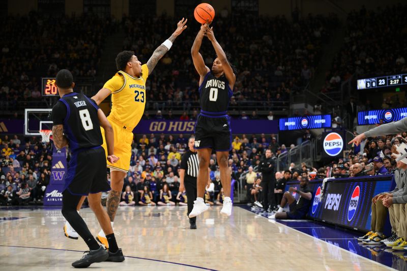 Jan 14, 2026; Seattle, Washington, USA; Washington Huskies guard Quimari Peterson (0) shoots a three point shot over Michigan Wolverines forward Yaxel Lendeborg (23) during the first half at Alaska Airlines Arena at Hec Edmundson Pavilion. Mandatory Credit: Steven Bisig-Imagn Images