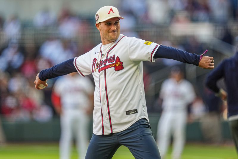 Apr 21, 2024; Cumberland, Georgia, USA; Atlanta Falcons quarterback Kirk Cousins throws out the first pitch prior to the game between the Atlanta Braves against the Texas Rangers at Truist Park. Mandatory Credit: Dale Zanine-USA TODAY Sports
