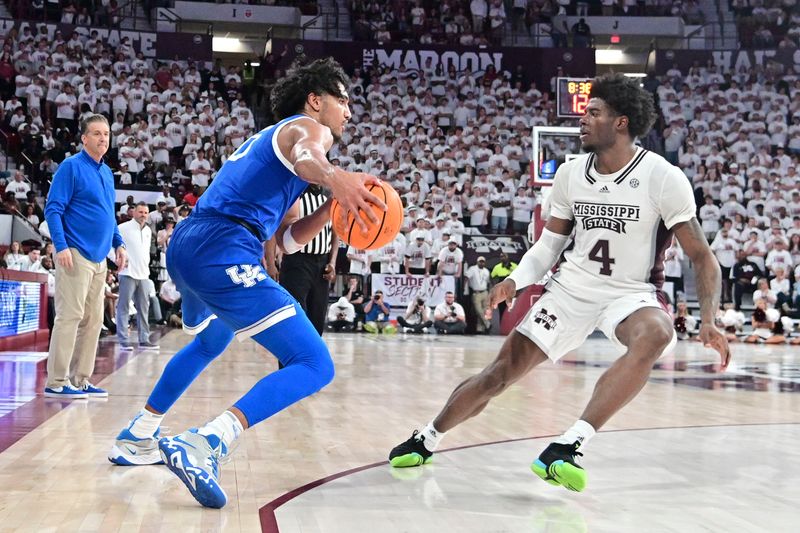 Feb 15, 2023; Starkville, Mississippi, USA;  Kentucky Wildcats forward Jacob Toppin (0) handles the ball while defended by Mississippi State Bulldogs guard Cameron Matthews (4) during the second half at Humphrey Coliseum. Mandatory Credit: Matt Bush-USA TODAY Sports