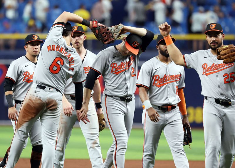 Jun 10, 2024; St. Petersburg, Florida, USA;Baltimore Orioles shortstop Gunnar Henderson (2), first base Ryan Mountcastle (6) and teammates celebrates after they beat the Tampa Bay Rays at Tropicana Field. Mandatory Credit: Kim Klement Neitzel-USA TODAY Sports