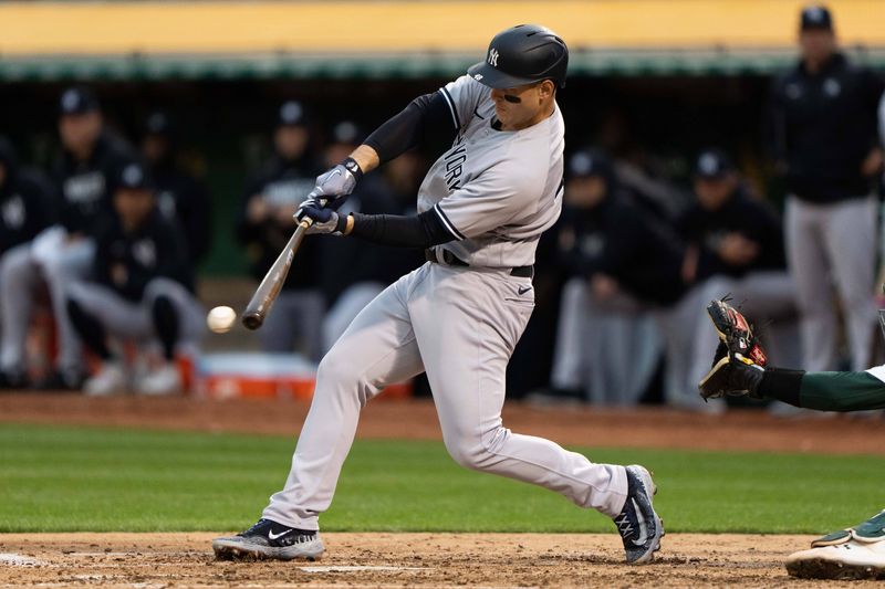 Jun 28, 2023; Oakland, California, USA;  New York Yankees first baseman Anthony Rizzo (48) hits a RBI single during the fifth inning against the Oakland Athletics at Oakland-Alameda County Coliseum. Mandatory Credit: Stan Szeto-USA TODAY Sports