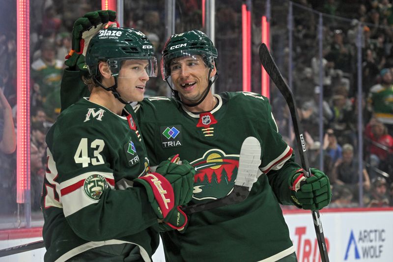 Sep 28, 2025; Saint Paul, Minnesota, USA;  Minnesota Wild forward Vinnie Hinostroza (18) congratulates forward Hunter Haight (43) on his goal against the Chicago Blackhawks during the second period at Xcel Energy Center. Mandatory Credit: Nick Wosika-Imagn Images
