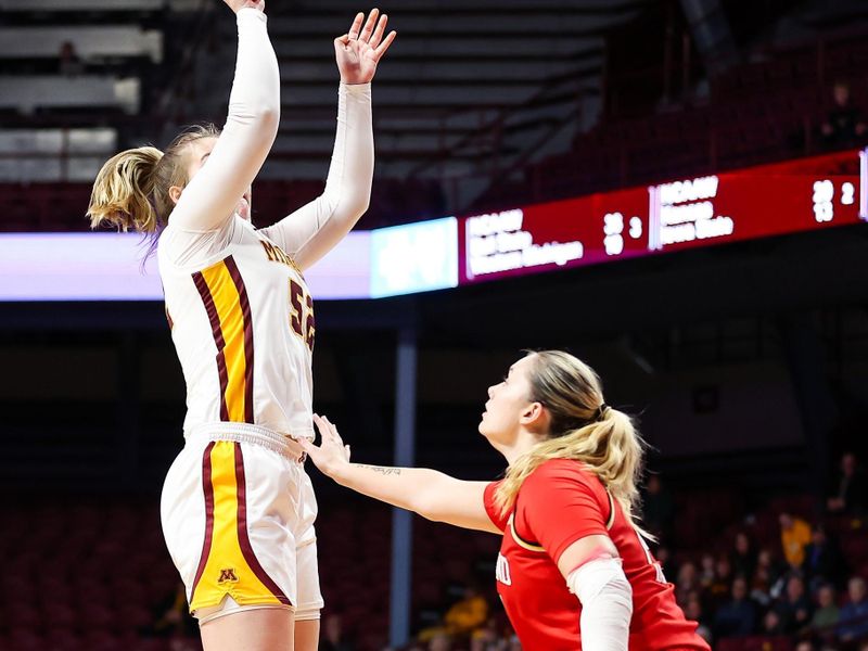 Jan 3, 2024; Minneapolis, Minnesota, USA; Minnesota Golden Gophers center Sophie Hart (52) shoots as Maryland Terrapins forward Allie Kubek (14) defends during the first half at Williams Arena. Mandatory Credit: Matt Krohn-USA TODAY Sports