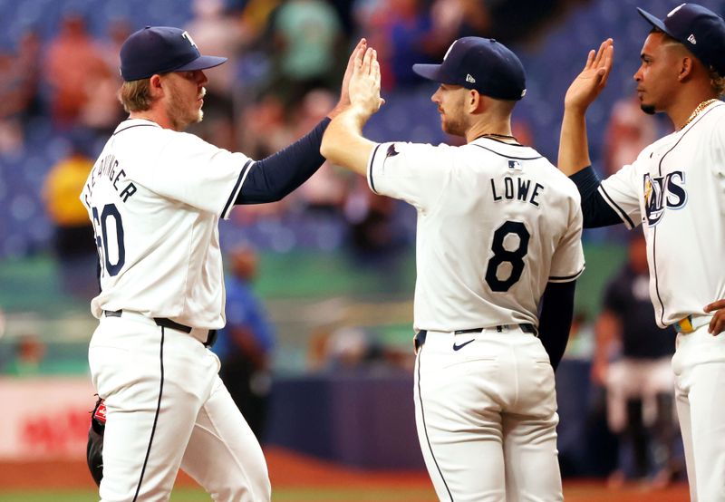 Sep 3, 2024; St. Petersburg, Florida, USA; Tampa Bay Rays outfielder Jose Siri (22), and designated hitter Brandon Lowe (8) celebrate as they beat the Minnesota Twins at Tropicana Field. Mandatory Credit: Kim Klement Neitzel-Imagn Images