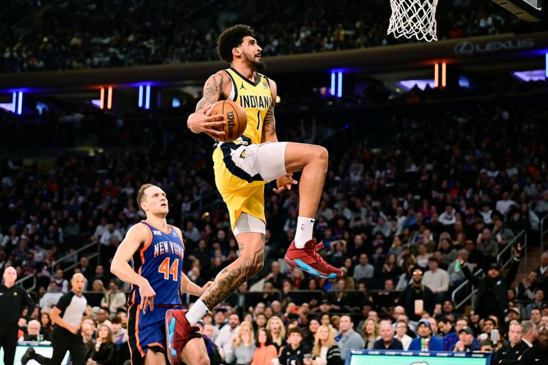 NEW YORK, NEW YORK - FEBRUARY 10:  Obi Toppin #1 of the Indiana Pacers attempts to dunk the ball against Bojan Bogdanovic #44 of the New York Knicks during the first half at Madison Square Garden on February 10, 2024 in New York City. NOTE TO USER: User expressly acknowledges and agrees that, by downloading and or using this photograph, User is consenting to the terms and conditions of the Getty Images License Agreement. (Photo by Steven Ryan/Getty Images)