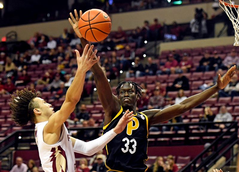 Feb 11, 2023; Tallahassee, Florida, USA; Florida State Seminoles guard Jalen Warley (1) shoots around Pittsburgh Panthers center Federiko Federiko (33) during the first half at Donald L. Tucker Center. Mandatory Credit: Melina Myers-USA TODAY Sports