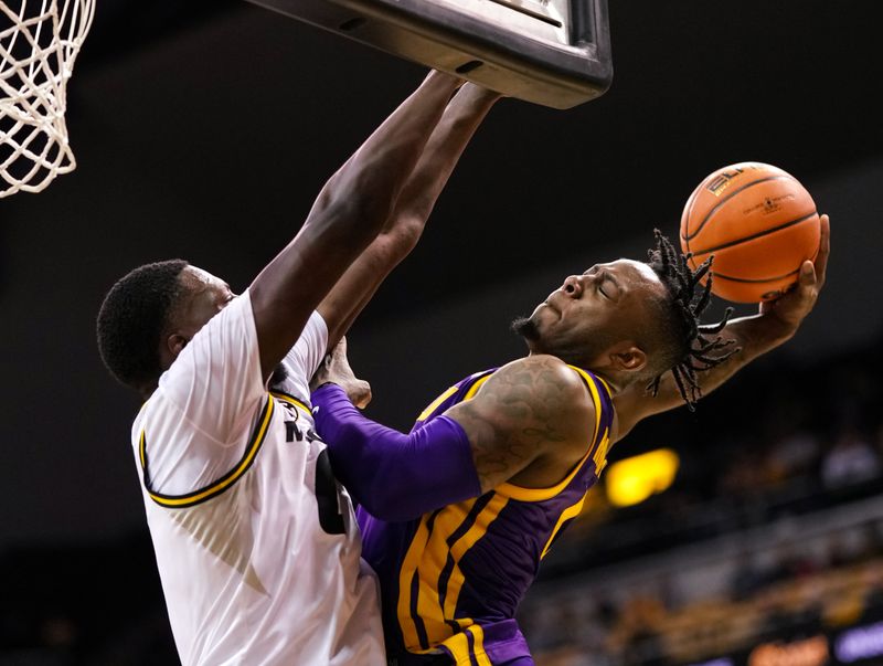 Feb 1, 2023; Columbia, Missouri, USA; LSU Tigers guard Trae Hannibal (0) goes up for a dunk against Missouri Tigers forward Mohamed Diarra (0) during the second half at Mizzou Arena. Mandatory Credit: Jay Biggerstaff-USA TODAY Sports