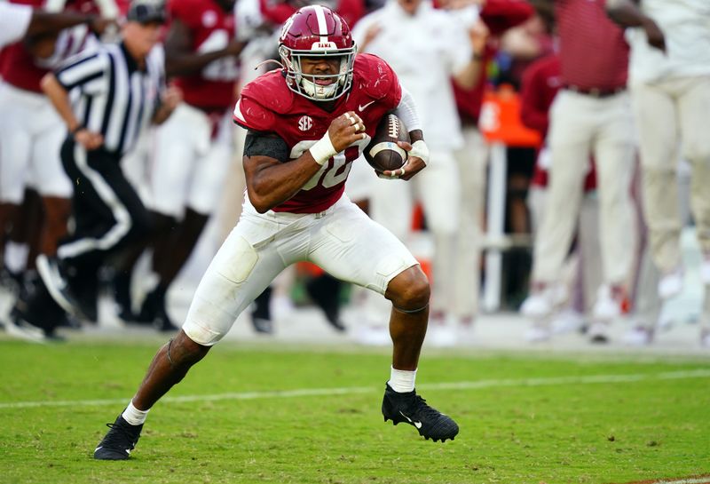 Oct 21, 2023; Tuscaloosa, Alabama, USA; Alabama Crimson Tide linebacker Jihaad Campbell (30) picks up a fumble and ran it back for a touchdown against the Tennessee Volunteers during the second half at Bryant-Denny Stadium. Mandatory Credit: John David Mercer-USA TODAY Sports