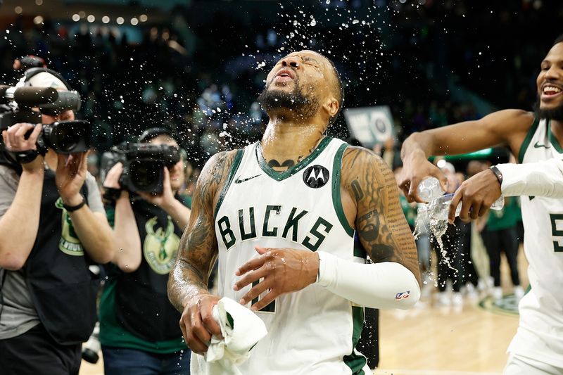 MILWAUKEE, WISCONSIN - JANUARY 14: Damian Lillard #0 of the Milwaukee Bucks reacts after getting water dumped over him celebrating his game winning shot against the Sacramento Kings at Fiserv Forum on January 14, 2024 in Milwaukee, Wisconsin. NOTE TO USER: User expressly acknowledges and agrees that, by downloading and or using this photograph, User is consenting to the terms and conditions of the Getty Images License Agreement. (Photo by John Fisher/Getty Images)