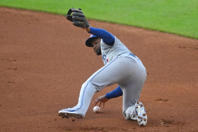 Jun 21, 2024; Cleveland, Ohio, USA; Toronto Blue Jays second baseman Orelvis Martinez (13) commits a fielding error in the second inning against the Cleveland Guardians at Progressive Field. Mandatory Credit: David Richard-USA TODAY Sports