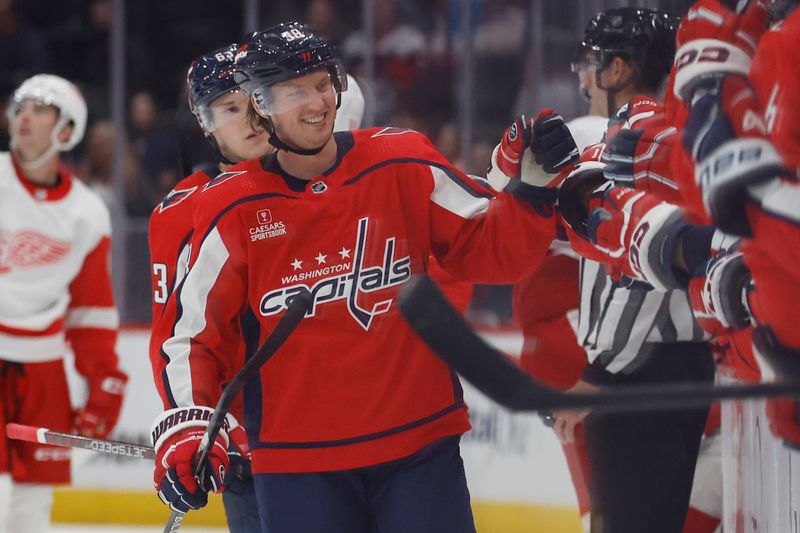 Sep 28, 2023; Washington, District of Columbia, USA; Washington Capitals defenseman Rasmus Sandin (38) celebrates with teammates after scoring a goal against the Detroit Red Wings in the third period at Capital One Arena. Mandatory Credit: Geoff Burke-USA TODAY Sports