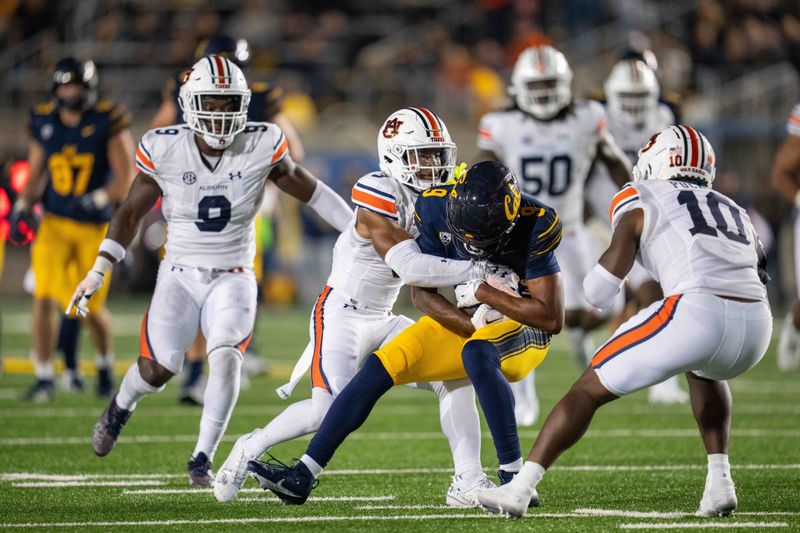 Sep 9, 2023; Berkeley, California, USA; California Golden Bears wide receiver Taj Davis (9) is tackled by Auburn Tigers cornerback Kayin Lee (3) during the fourth quarter at California Memorial Stadium. Mandatory Credit: Neville E. Guard-USA TODAY Sports