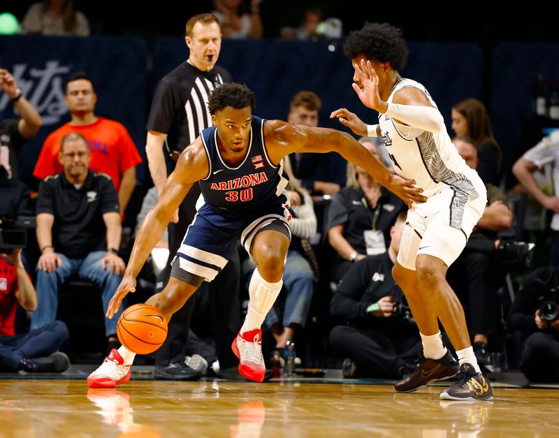 Jan 17, 2026; Orlando, Florida, USA;  Arizona Wildcats forward Tobe Awaka (30) tries to move towards the basket in the first half against the Central Florida Knights at Addition Financial Arena. Mandatory Credit: Russell Lansford-Imagn Images