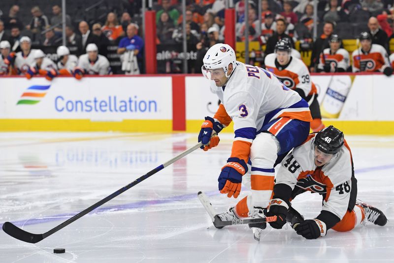 Sep 26, 2024; Philadelphia, Pennsylvania, USA; New York Islanders defenseman Adam Pelech (3) and Philadelphia Flyers center Morgan Frost (48) battle for the puck during the third period at Wells Fargo Center. Mandatory Credit: Eric Hartline-Imagn Images