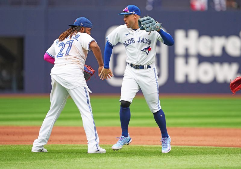 Sep 9, 2023; Toronto, Ontario, CAN; Toronto Blue Jays right fielder George Springer (4) celebrates the win with first baseman Vladimir Guerrero Jr. (27) against the Kansas City Royals at the end of the ninth inning at Rogers Centre. Mandatory Credit: Nick Turchiaro-USA TODAY Sports