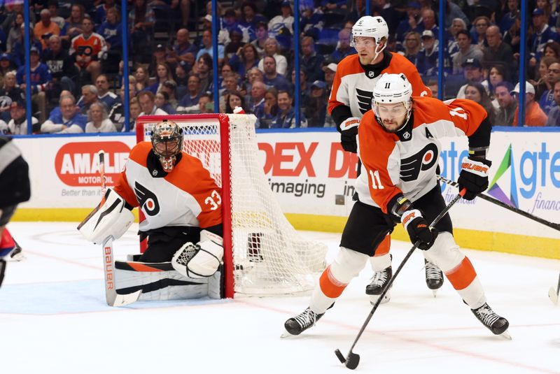 Mar 9, 2024; Tampa, Florida, USA; Philadelphia Flyers right wing Travis Konecny (11) passes the puck against the Tampa Bay Lightning during the first period at Amalie Arena. Mandatory Credit: Kim Klement Neitzel-USA TODAY Sports