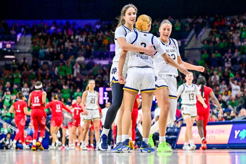 Mar 3, 2024; South Bend, Indiana, USA; Notre Dame Fighting Irish guard Sonia Citron (11) guard Hannah Hidalgo (3) and forward Kylee Watson (22) celebrate in the second half against the Louisville Cardinals at the Purcell Pavilion. Mandatory Credit: Matt Cashore-USA TODAY Sports